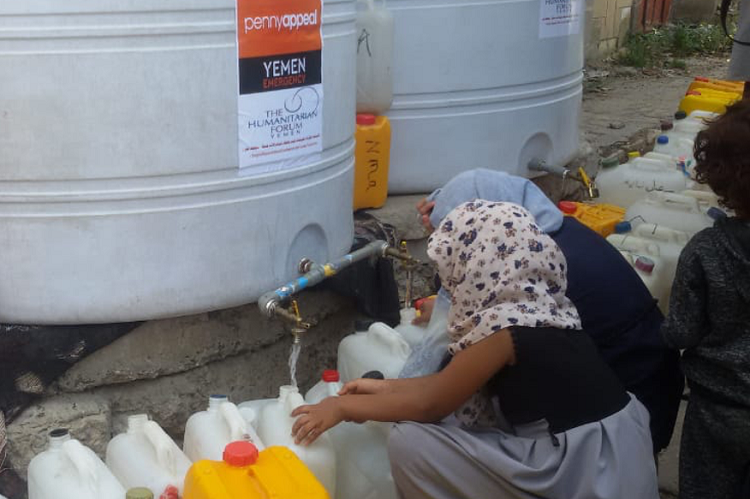 Children filling up bottles from a Penny Appeal water tank