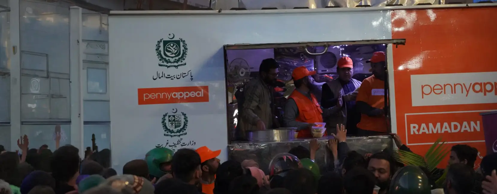 Food being distributed during Ramadan by a Penny Appeal food truck.