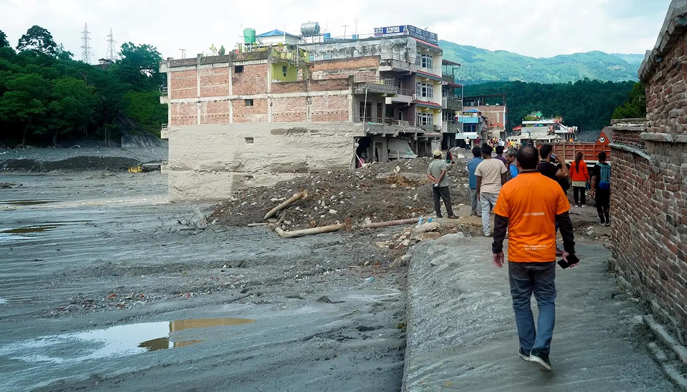 Penny Appeal worker looks at destroyed building in Nepal.
