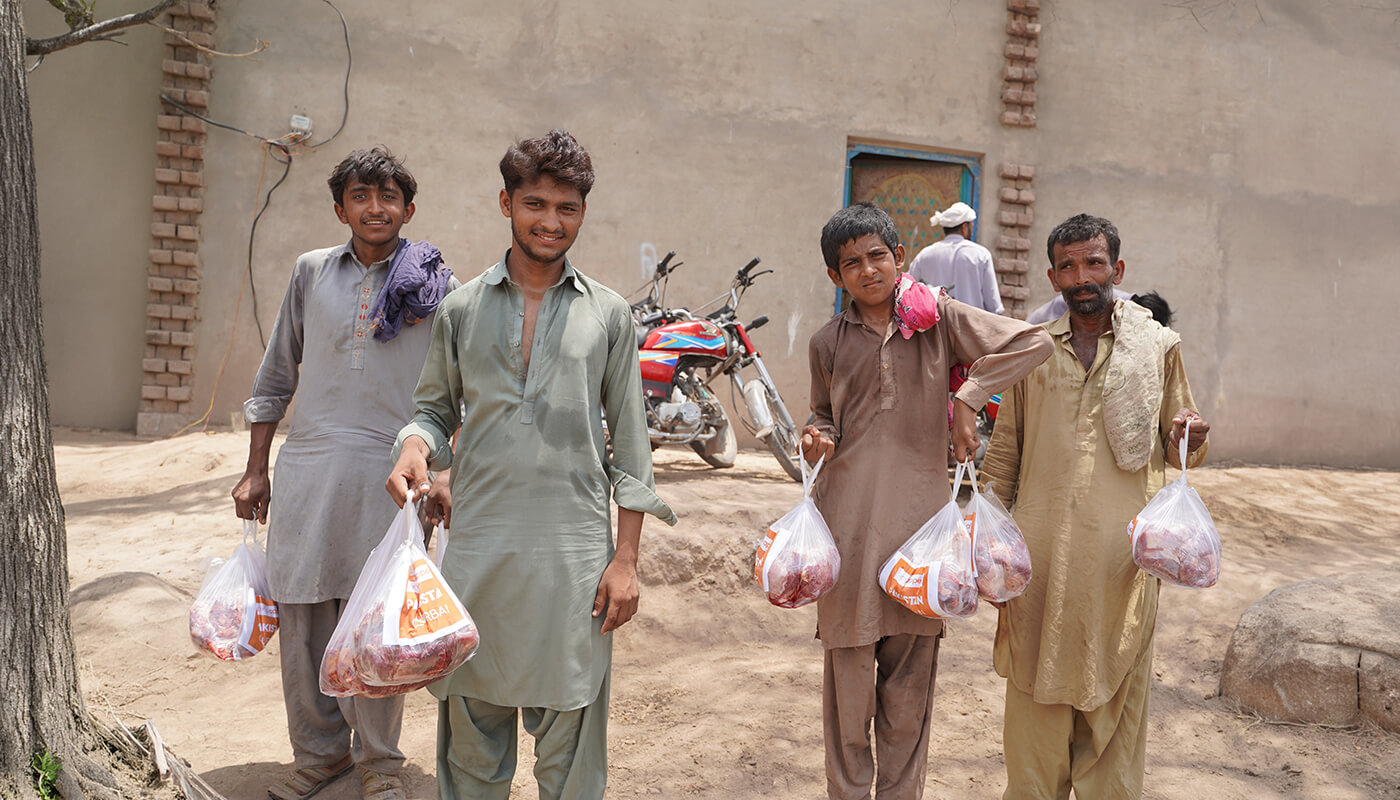 Qurbani donated by Penny Appeal donors being picked up by beneficiaries at a distribution tent in Pakistan.