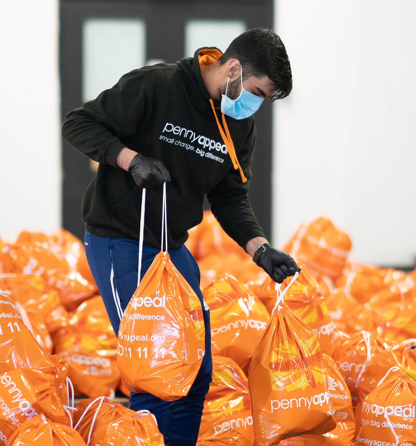 Penny Appeal volunteer packing Winter Emergency packs for the homeless and needy in the UK.